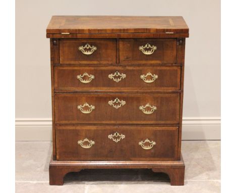 A George II walnut fold over bachelors chest, the crossbanded folding top above two short and three graduated conforming long