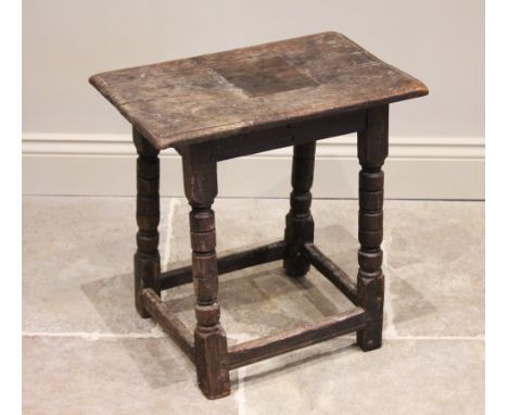 An 18th century oak joint stool, the rectangular moulded top raised raised upon turned tapering and block supports, united by