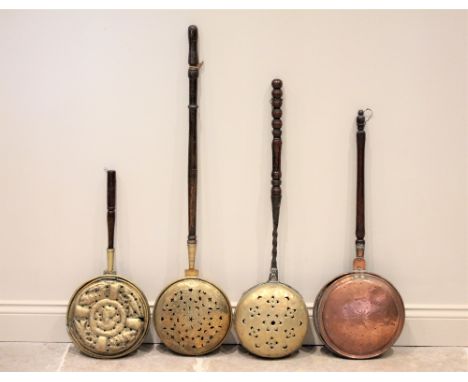A 17th/18th century Dutch brass warming pan, the domed cover with pierced flower head motifs, applied with a wrought iron twi