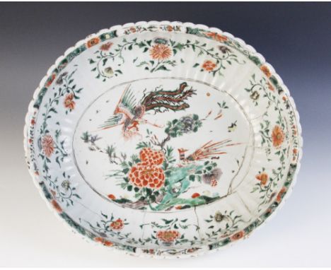 A Chinese porcelain famille verte basin (Kangxi 1661-1722) the oval fluted body decorated internally to the centre with a pho