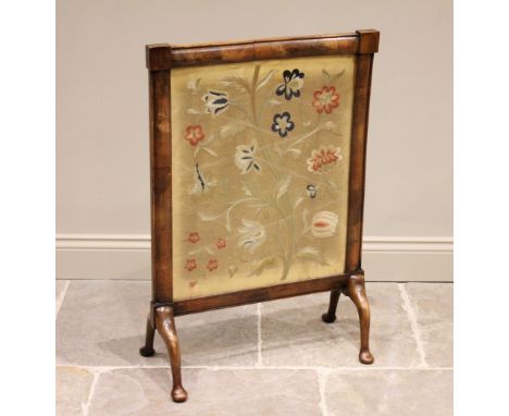 * A mid-19th century mahogany framed crewel work inset fire screen, depicting a floral spray, raised on out-swept legs, 89cm 