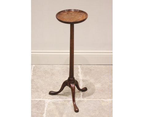 A George III mahogany candle stand or wine table, the circular top with moulded raised rim, raised upon a plain tapering colu