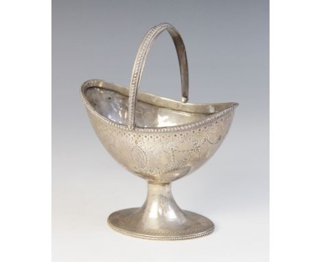 A silver coloured swing-handled sugar basket, the oval body upon spreading base, with beaded borders and foliate swag decorat