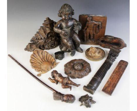 A selection of carved wood items, to include a carved oak panel, carved with a figure, 21cm high, a fruitwood cribbage board,
