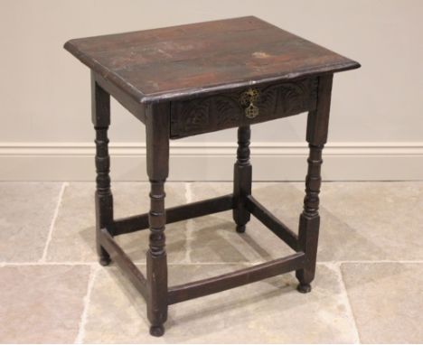 A 17th century and later oak side table, the rectangular three board top above a single frieze drawer carved with lunette det