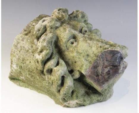 A carved stone corbel, depicting a bearded male head with distinctive flowing hair in the medieval manner, 30cm long, 22cm hi