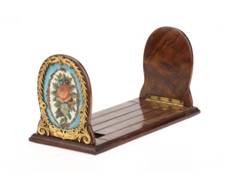 An Edward VII Burr Walnut Book Trough,on adjustable slide and with Sevres style bleu celeste and gilt panels reverse printed 