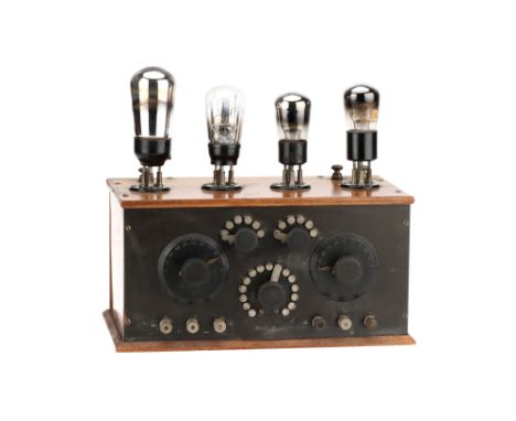 An Early French Valve Radio,French, c.1920, polished fruitwood case with vulcanite control panel to the front, 4 valves along