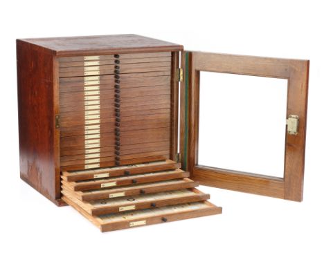 A Microscope Slide Cabinet and Slides,substantial oak cabinet by Beck, London, c.1925-1950, glazed door with lock and key, 28