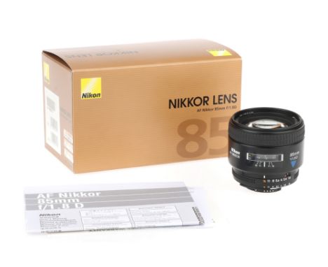 A Nikon AF Nikkor 85mm f/1.8D Lens,body VG-E, optics VG, some light dust present, in makers box, no caps, no hood,