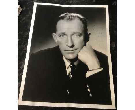 Bing Crosby signed 10 x 8 inch b/w photo dedicated. Crosby a little light. Condition 7/10. All autographs come with a Certifi