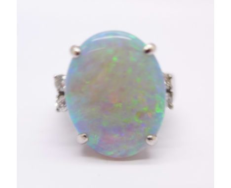An opal and diamond ring set in white metal marked 18k, 7.2g, L, opal 17 x 13mm
