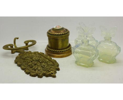 Three French iridescent glass butterfly top perfume bottles, a brass coat hook and a brass trinket box with porcelain panel