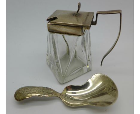 A Dutch silver caddy spoon and a silver topped mustard/salt pot with silver spoon, chips to the glass