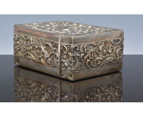 Victorian white metal playing cards case, by William Comyns, similarly unmarked, embossed with scrolls and frolicking cherubs