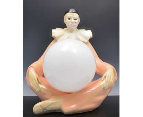 Novelty painted composition table lamp, designed as a seated Pierrot, with a globe shade, 45cm.