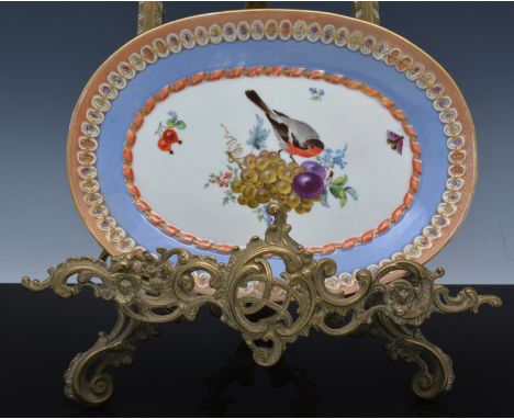 Meissen oval dessert dish, reserve painted with a bird, butterfly and fruit, moulded and banded surround, 23cm.