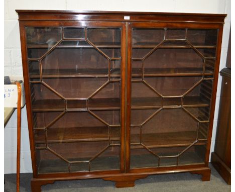 Mahogany bookcase, narrow frieze, fitted with two astragal glazed panel doors, bracket feet, 152cm, height 143cm.