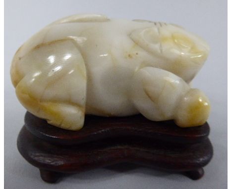 An Oriental White Jade Carving of a Recumbent Cat on Hardwood Stand. 7cm Long