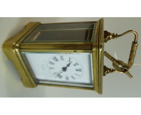 A French Brass Cased Carriage Clock. The Enamelled Dial Inscribed for Benetfink and Co, London. 15cms High with Handle Raised