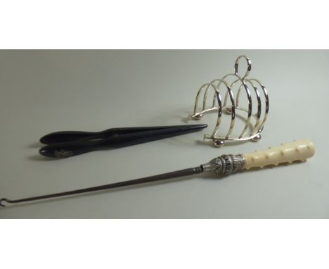 A 19th Century Ivory Handled Button Hook, a Pair of Ebonised Glove Stretchers and a Silver Plated Horseshoe Toast Rack