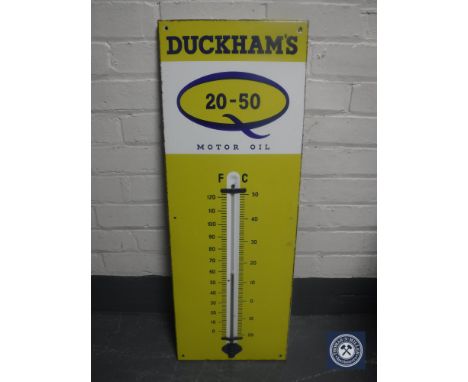 A mid 20th century Duckhams Motor Oil enamelled sign with thermometer 