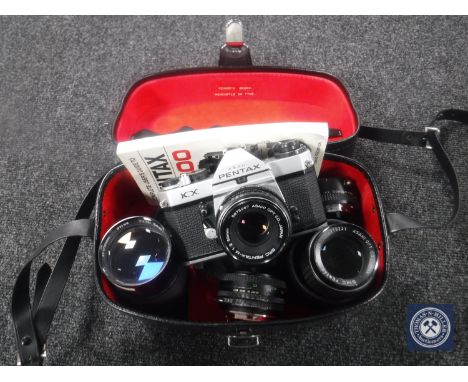 A camera case containing a Pentax KX camera with four lenses  CONDITION REPORT: The camera has an Asahi SMC Pentax-M 1: 50mm 