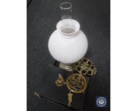 A tray of chrome oil lamp with glass chimney and shade, brass toasting fork, two brass trivets, brass bell, box of table cutl