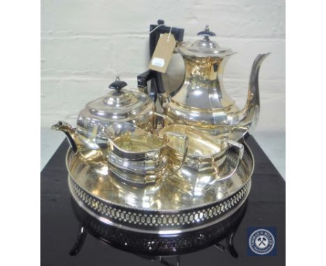 A four-piece Sheffield plated tea service on circular gallery tray 