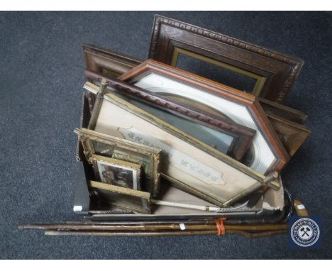 A box of Edwardian and later framed prints, tapestry and a bundle of walking sticks 