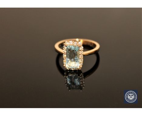 A 14ct yellow gold aquamarine and diamond ring, the rectangular, step-cut, light-blue aquamarine weighing 1.15 carat, within 