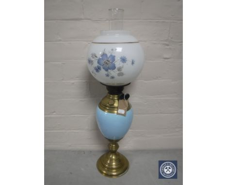 A Victorian brass and china oil lamp with glass chimney and shade 