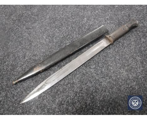 A German bayonet in sheath CONDITION REPORT: The blade is stamped BK. Aside from this there are no markings. The scabbard is 