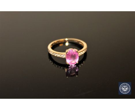 A 14ct yellow gold sapphire and diamond ring, an oval-cut pink sapphire weighing 1.40 carat within a four-claw setting, the s