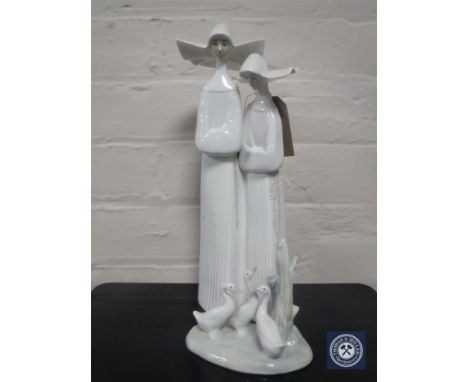 A Lladro figure of two nuns, number 4611, together with a Nao figure of ducks (both boxed)  CONDITION REPORT: Both figures in