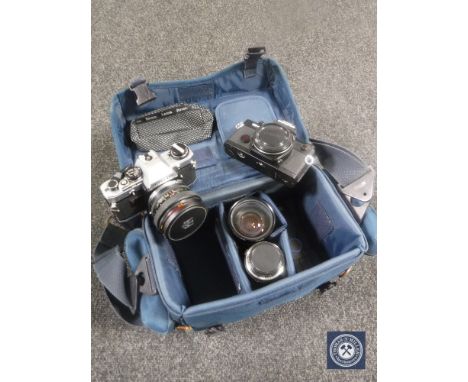 A camera bag containing an Olympus OM4 and OM10, 24 mm multi-filter lens etc 