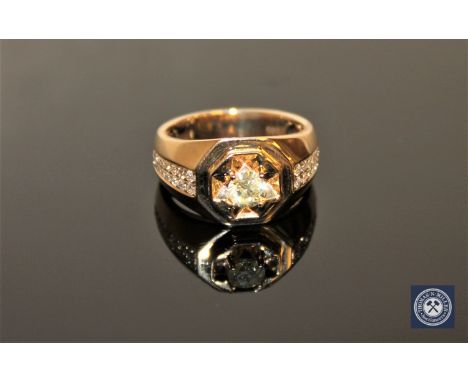 A 14ct yellow gold gent's signet ring, the central brilliant-cut diamond weighing 0.58 carat, clarity I1 and colour K, the sh
