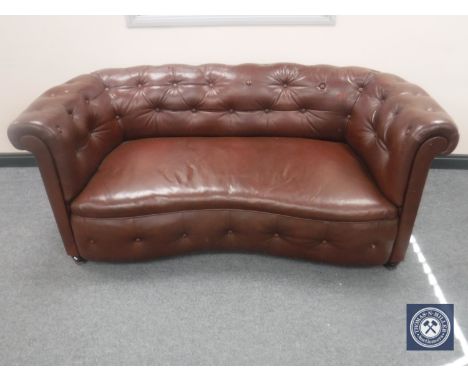 A brown button leather shaped settee 