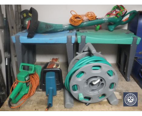 A hose pipe on reel, four garden kneelers, two strimmers and two hedge trimmers 