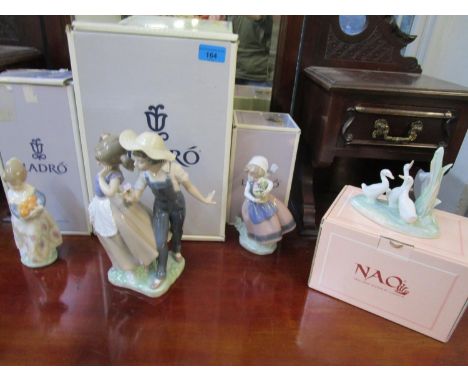 Three Lladro porcelain figurines, and a Nao model of three geese, all boxed 