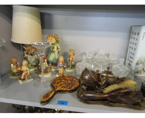 A group of six Hummel figurines and a Hummel style table lamp, a pressed glass dressing table set, a simulated tortoiseshell 