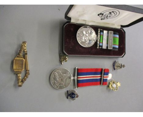 A war medal 1939-1945 together with a Battle of Britain commemorative medal enamel pins and a Swiss watch case marked 18k 