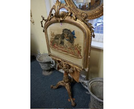 A 19th century gilt framed tripod firescreen,&nbsp;with embroidered panel of spaniel, 127cm high.&nbsp; 