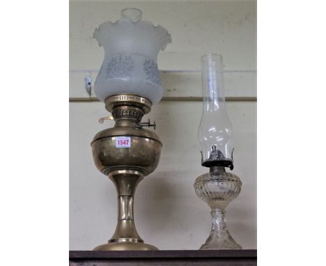 A brass oil lamp,&nbsp;height including shade 51.5cm; and another similar glass example.&nbsp; 