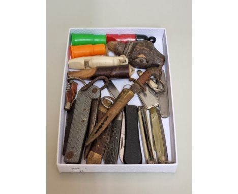 A small collection of vintage knives and whistles, together with a novelty carved wood otter's head stopper. 