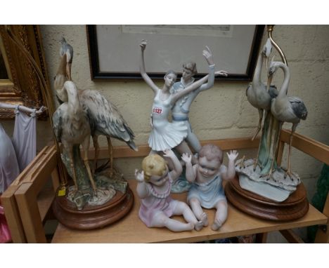 A large Nao figure group,&nbsp;40cm high; together with a pair of Capodimonte heron table lamps, (s.d. to one); and a pair of
