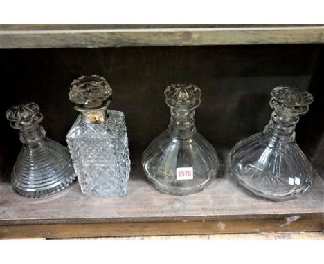 A silver mounted cut glass decanter and stopper;&nbsp;together with another small cut glass decanter and stopper; and one oth