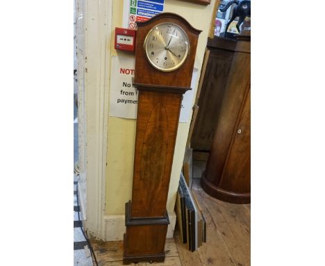 A 1930s walnut small longcase clock,&nbsp;striking on eight straight gongs, 135.5cm high, with pendulum. 