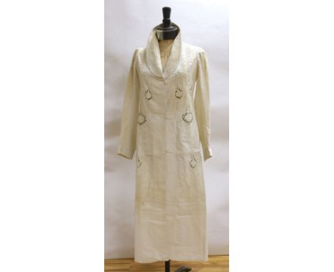 An Edwardian white/cream linen lady's coat with cut work detail and unusual button detail to the back