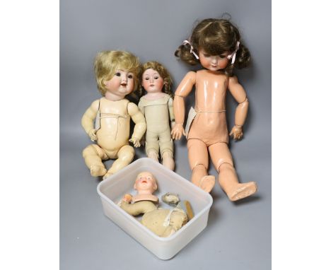 A kid leather bodied jointed limb open mouth Heubach bisque headed doll together with two other bisque headed dolls and a boy